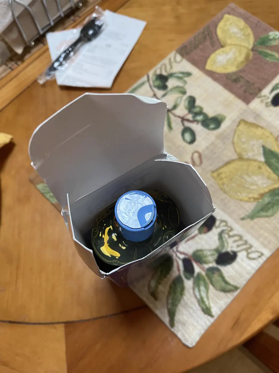 Opened shipping box with a blue-capped T/Gel bottle inside