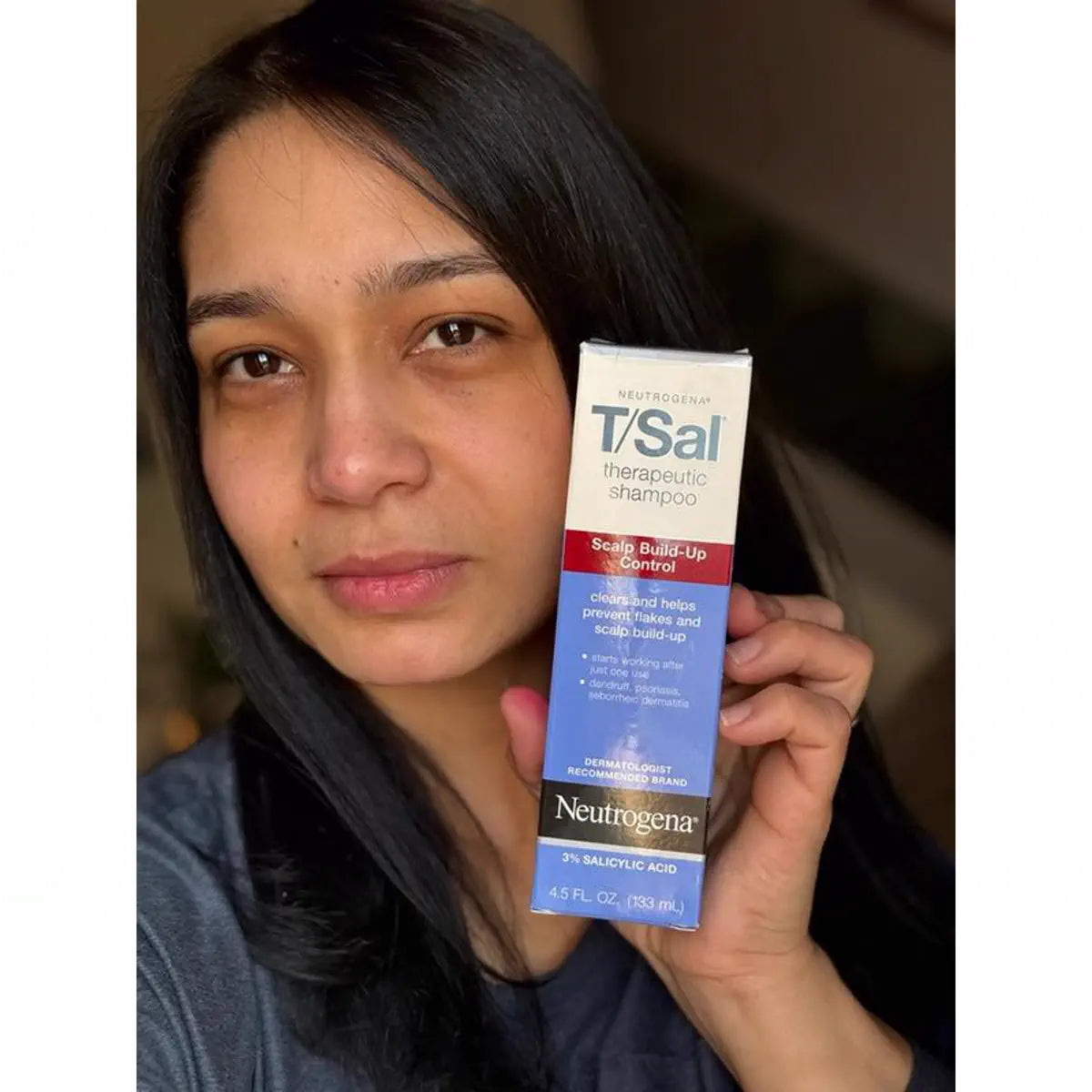 Customer holding a T/Gel carton beside her face