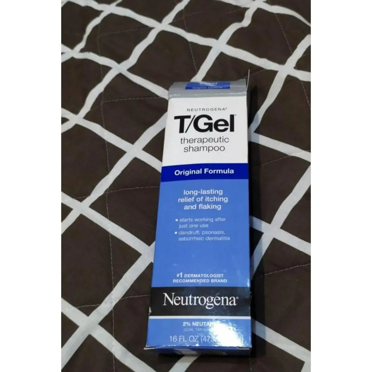 T/Gel carton on black and white patterned fabric