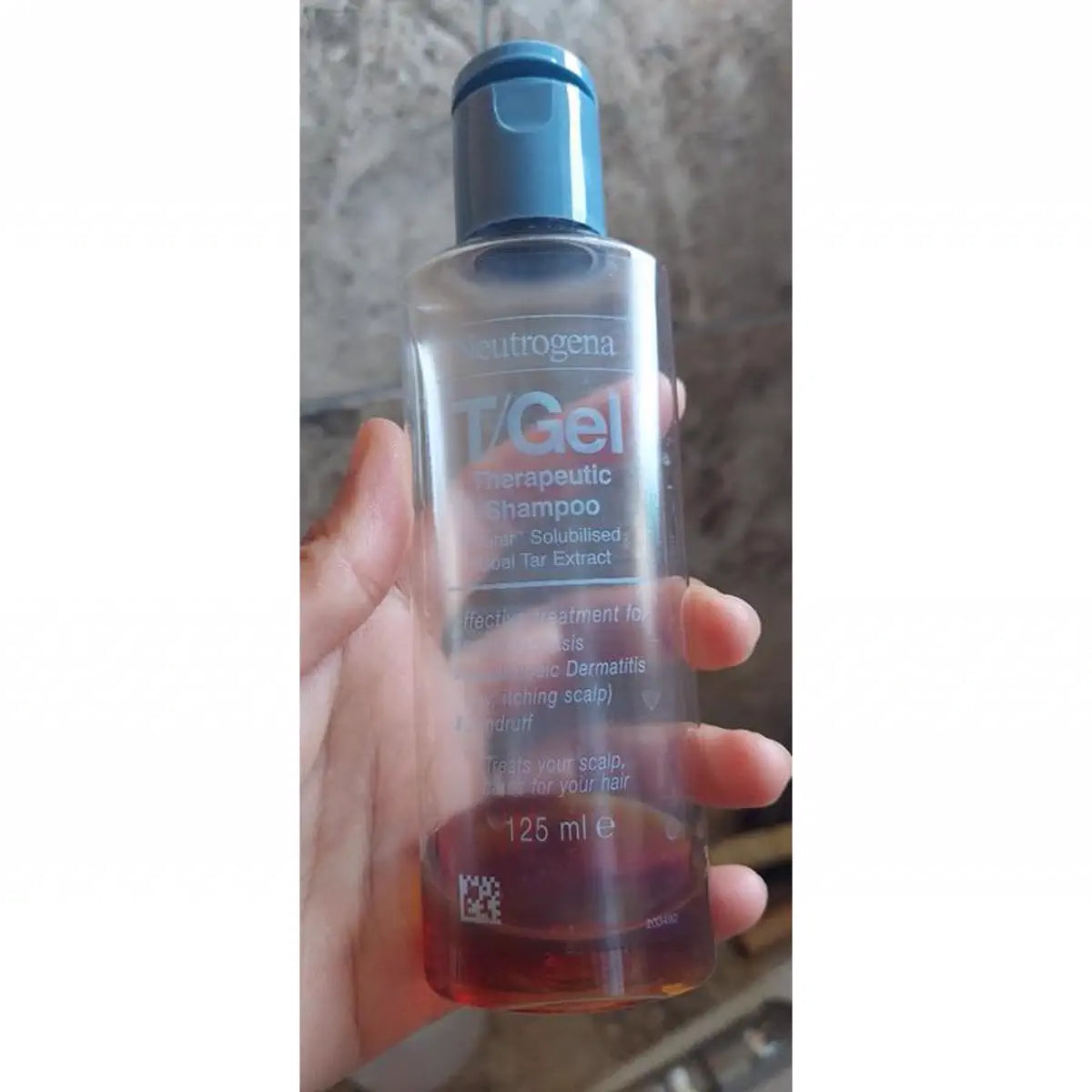 Nearly empty earlier T/Gel bottle held in hand